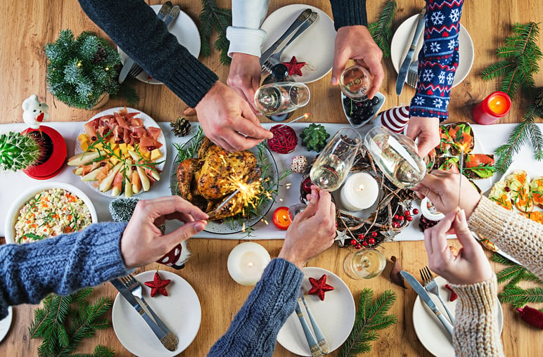 baked-turkey-christmas-dinner-christmas-table-is-served-with-turkey-decorated-with-bright-tinsel-candles-fried-chicken-table-family-dinner-top-view-hands-frame