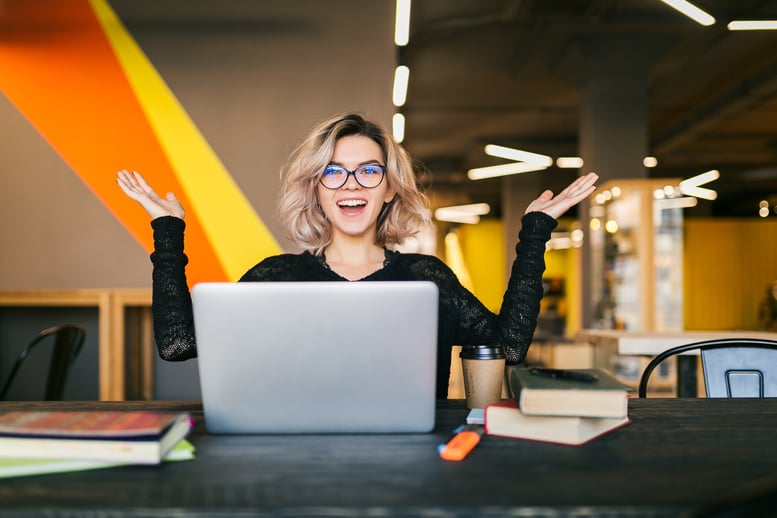funny-happy-excited-young-pretty-woman-sitting-table-black-shirt-working-laptop-co-working-office-wearing-glasses